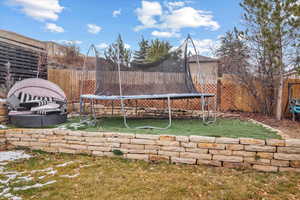 View of yard featuring a trampoline