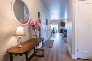 Hallway with hardwood / wood-style floors