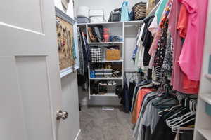 Spacious closet featuring carpet