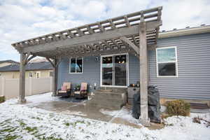 Snow covered house with a pergola