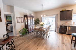 Dining area with a chandelier and light hardwood / wood-style floors