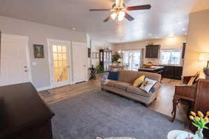 Living room featuring ceiling fan and light hardwood / wood-style flooring