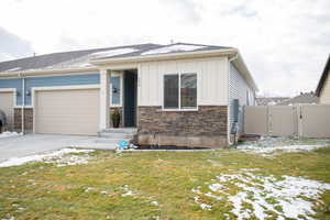 View of front facade with a garage and a lawn