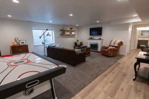 Game room with light hardwood / wood-style floors