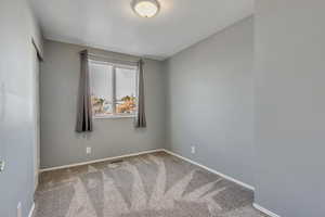 Carpeted bedroom with a textured ceiling