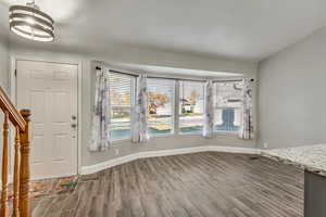 The entrance foyer features tile flooring and an inviting chandelier