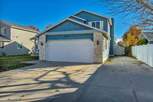 View of front facade with a garage and RV pad.