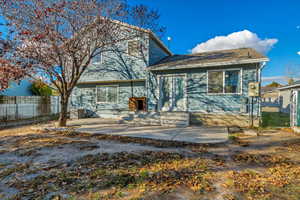 Rear view of house with central air condition unit and a patio area