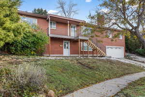 View of front of house with a balcony and a garage