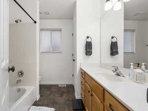 Full bathroom with vanity,  shower combination, and toilet