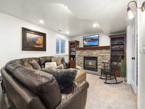 Living room with light carpet and a fireplace