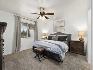 Bedroom featuring ceiling fan, carpet, and a textured ceiling