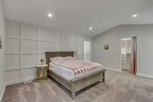 Primary bedroom with vaulted ceiling