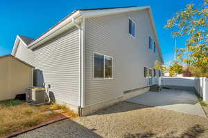 View of side of property featuring a patio area and central air condition unit