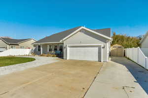 Ranch-style house featuring a front lawn , extra parking and a garage