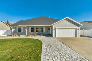 Ranch-style house with a front lawn and a garage