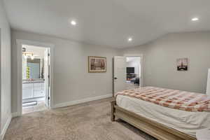 Primary bedroom with view into bathroom and living room