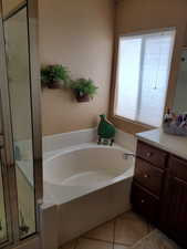 Bathroom with tile patterned floors and plus walk in shower