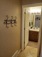 Bathroom with tile patterned floors and vanity