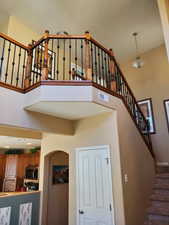 Stairway featuring a towering ceiling