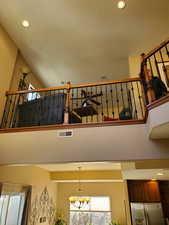 Stairway featuring a chandelier and a high ceiling