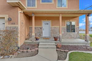 View of exterior entry with a porch