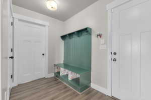 Mudroom with wood-type flooring and a textured ceiling