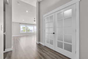 Corridor with hardwood / wood-style flooring and a textured ceiling