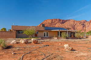 Back of property featuring a mountain view and french doors