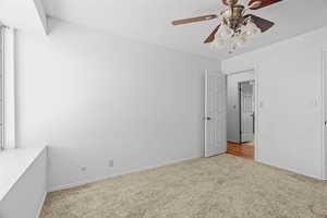 Unfurnished bedroom featuring carpet flooring, ceiling fan, and a textured ceiling