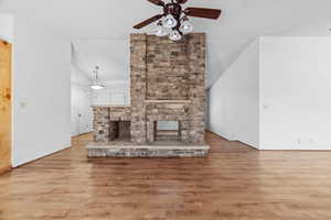 Unfurnished living room with a fireplace, hardwood / wood-style floors, and a textured ceiling