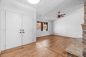 Entrance foyer featuring hardwood / wood-style floors, ceiling fan, and a textured ceiling