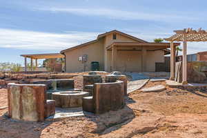 View of property exterior with central AC unit and a pergola