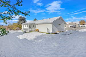 Back of house featuring a porch and a garage