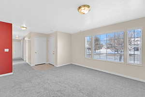 Carpeted spare room featuring a textured ceiling