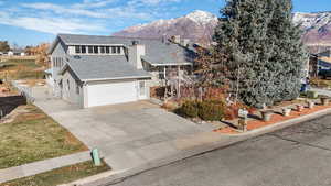 View of front of home featuring a mountain view and a garage