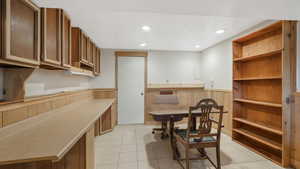 Dining area featuring light tile patterned flooring and a textured ceiling