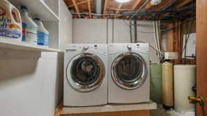 Clothes washing area featuring washer and dryer