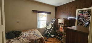 Bedroom with wood walls