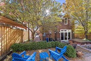 Rear view of property featuring french doors and a hot tub