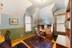 Office featuring light hardwood / wood-style floors and lofted ceiling