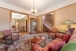 Living room with hardwood / wood-style flooring and an inviting chandelier