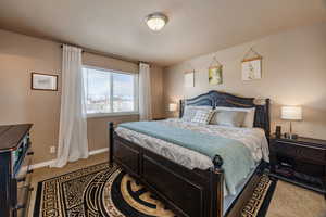 Master bedroom with walk in closet and a bathroom.