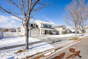 Side view of the house with fully fenced yard and mature trees.