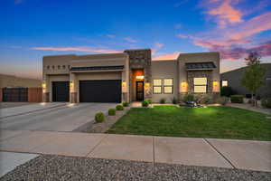 View of front facade with a lawn and a garage