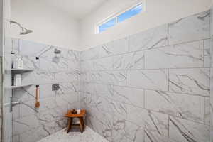 Bathroom featuring a tile shower