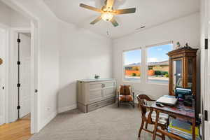 Carpeted office with ceiling fan