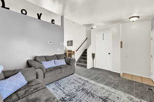 Tiled living room with a textured ceiling