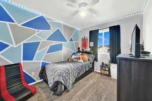 Carpeted bedroom with ceiling fan