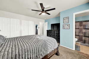 Bedroom featuring connected bathroom, carpet floors, ceiling fan, and multiple closets